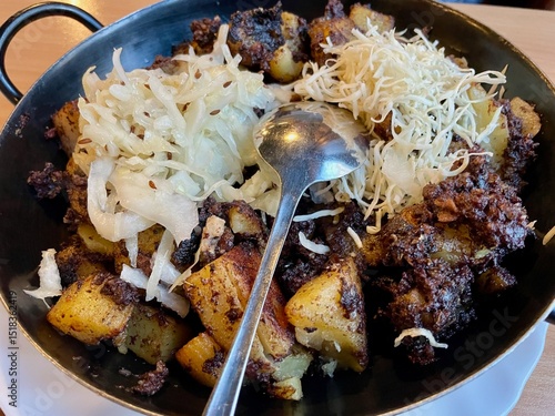 Blunzengröstl - traditional Austrian dish made of potatoes and blood pudding.