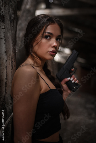 Wallpaper Mural Beautiful woman super agent with pistols in hands posing on abandoned building background.. Torontodigital.ca