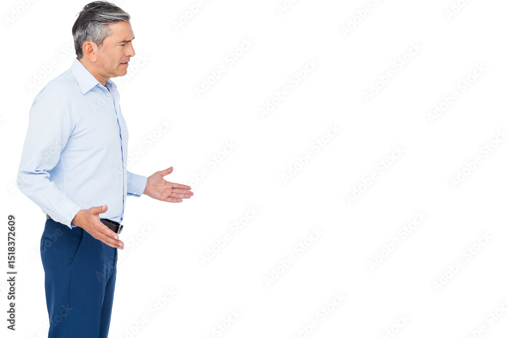 Mature adult man wearing business casual attire gesturing in studio with white backdrop, copy space Mature adult man wearing business casual attire gesturing in studio with white backdrop, copy space