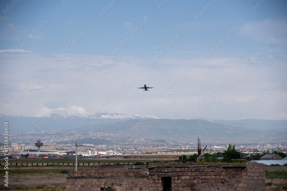 Fototapeta premium Passenger Plane Taking Off Against Blue Sky and Clouds
