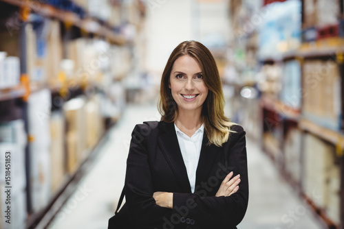 Ταπετσαρία Mid adult woman wearing business attire folding arms while supervising warehouse