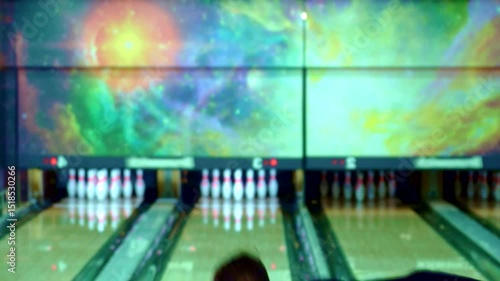 Confident guy holds a bowling ball on his shoulder
