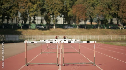 Dynamic sprinters soaring over hurdles in an exhilarating race