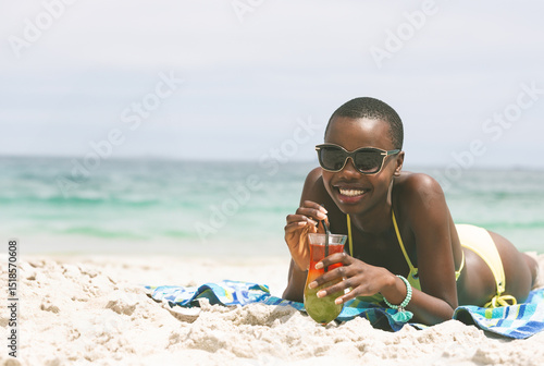 Canvas Print African American woman in yellow bikini lying on towel sipping cocktail at shore