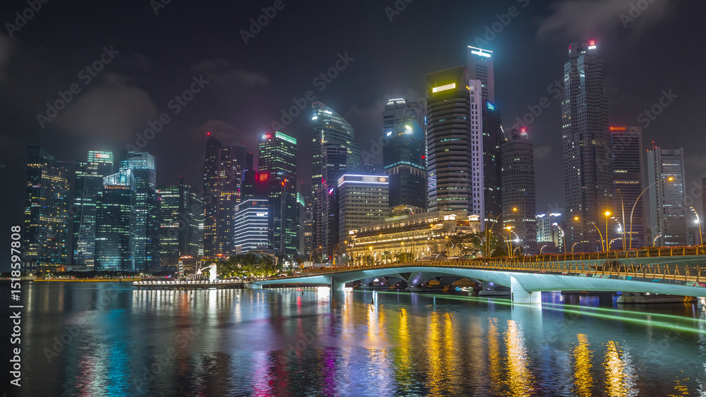Fototapeta premium Esplanade bridge and downtown core skyscrapers in the background Singapore night timelapse hyperlapse