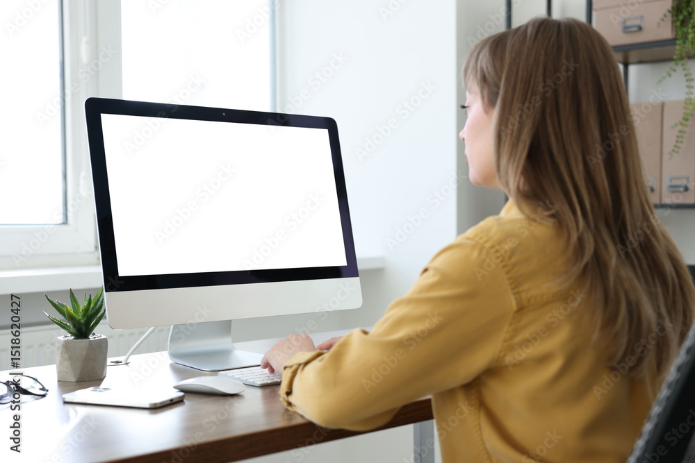 Woman working on computer at wooden desk in office. Mockup for design Woman working on computer at wooden desk in office. Mockup for design