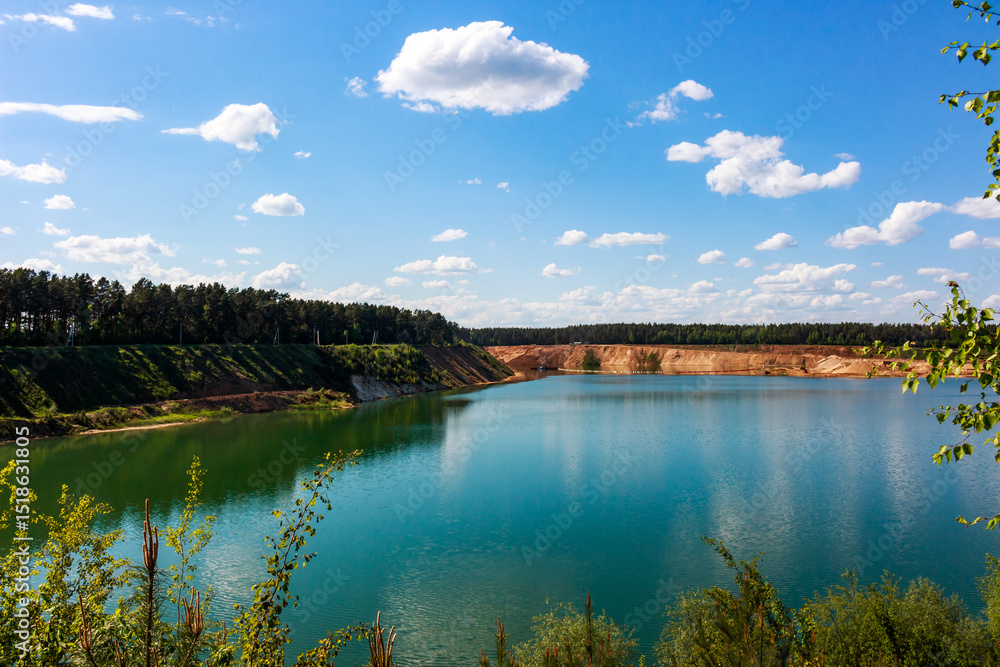 Fototapeta premium Large sand quarry artificially converted into a lake, panoramic view of the reservoir