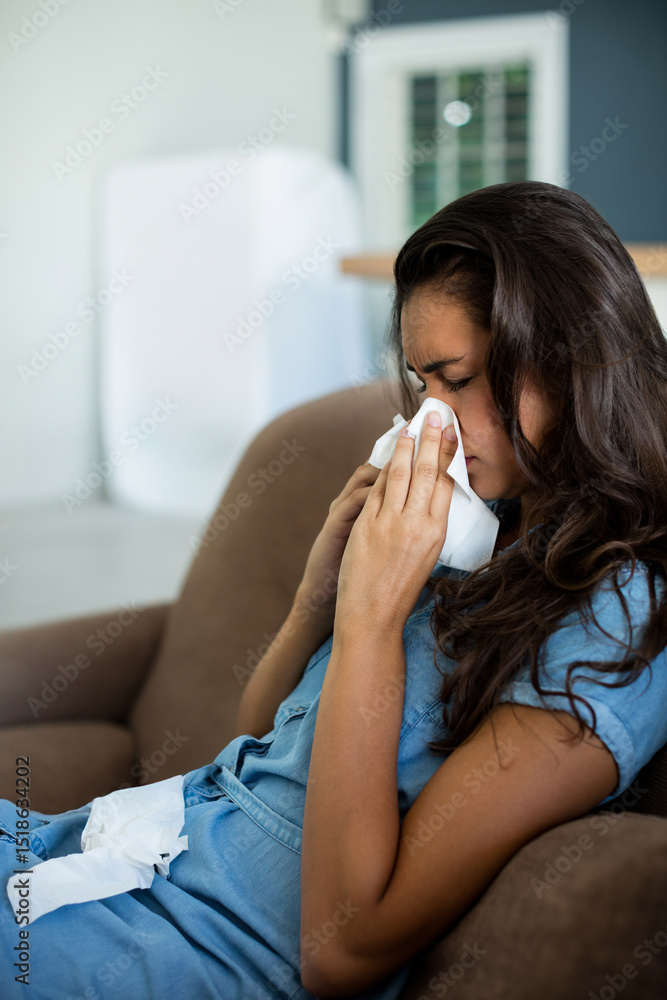 Brown sofa displaying folded white tissues and scattered tissues near air purifier by window blinds Brown sofa displaying folded white tissues and scattered tissues near air purifier by window blinds