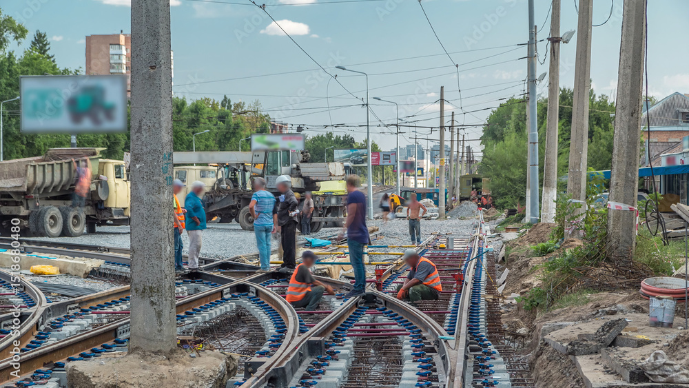Fototapeta premium Repair works on the street timelapse. Laying of new tram rails on a city street.