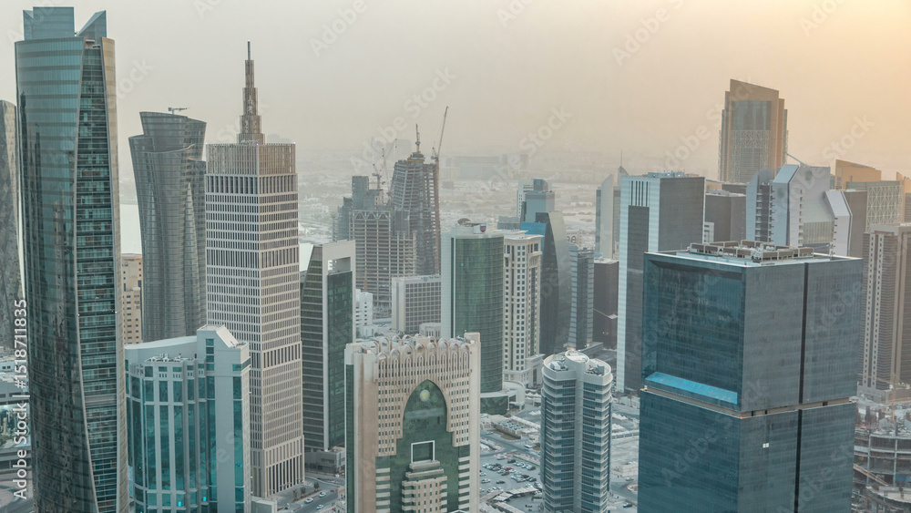 Fototapeta premium Skyscrapers before sunset timelapse in the skyline of commercial center of Doha, the capital Qatar
