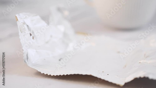 Eating a chocolate and dulce de leche alfajor from the original packaging.