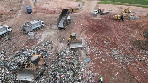 Drone top-down view of garbage trucks unloading at waste plant in São Paulo - 4K