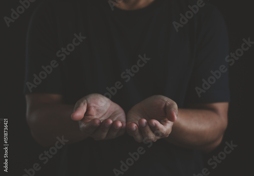 Fotografie Person give two hand on dark background