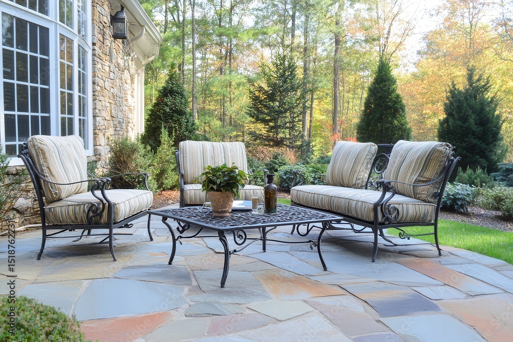 Obraz premium Cozy outdoor seating area with stylish furniture, surrounded by lush greenery and trees