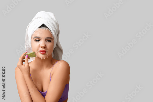 Young woman with sheet faci...
