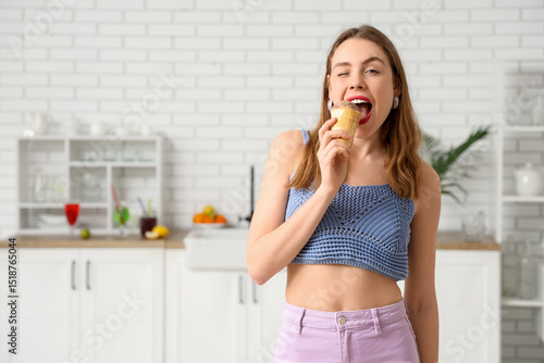 Young woman biting chocolat...