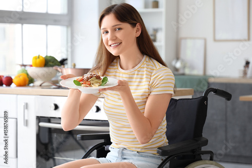 Young woman in wheelchair w...