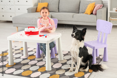 Cute little girl with dog p...