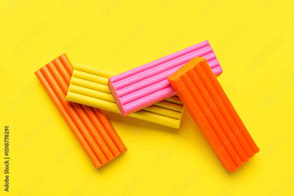 Fototapeta premium Colorful plasticine on yellow background