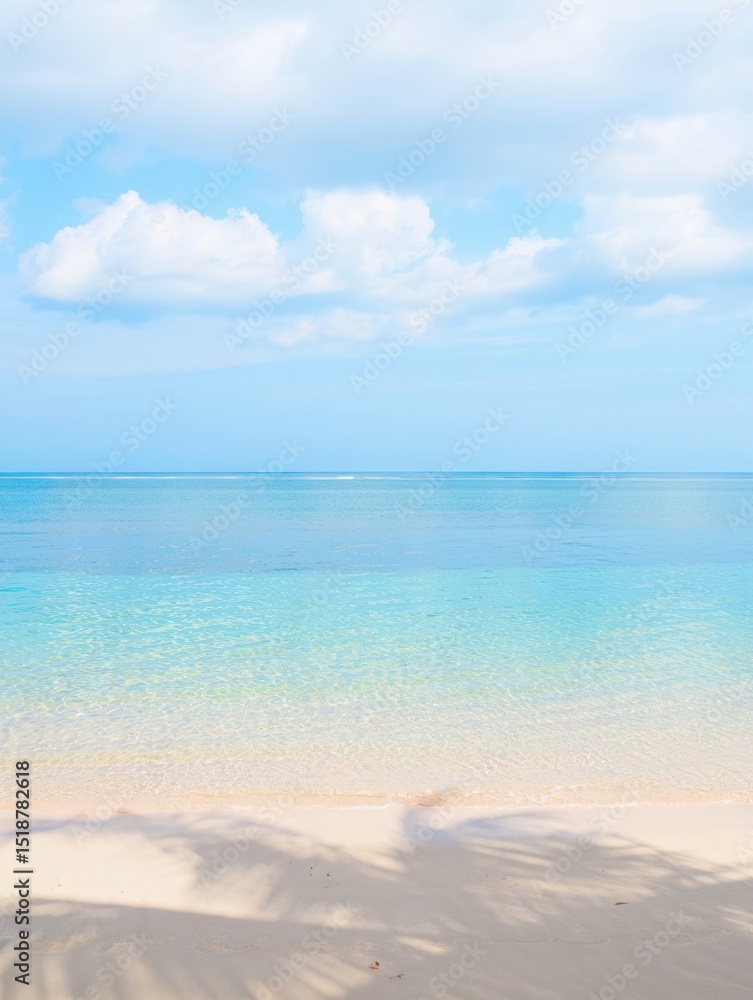 Fototapeta premium Calm beach scene with clear turquoise water, soft sandy shore, light cloud-filled sky, and gentle shadows from nearby palm trees, evoking peace and relaxation