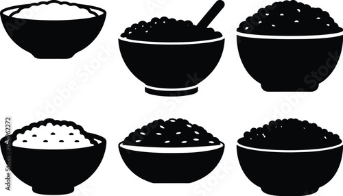 Collection of various black and white bowls filled with food or rice