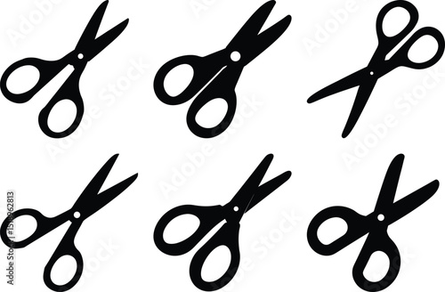 Black scissor silhouettes in different shapes, oriented in different directions, set on white
