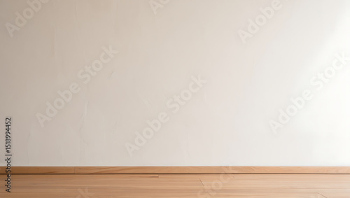 Empty room with white wall and light wood floor