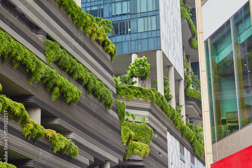 Modern architecture featuring green balconies with lush plants in an urban environment