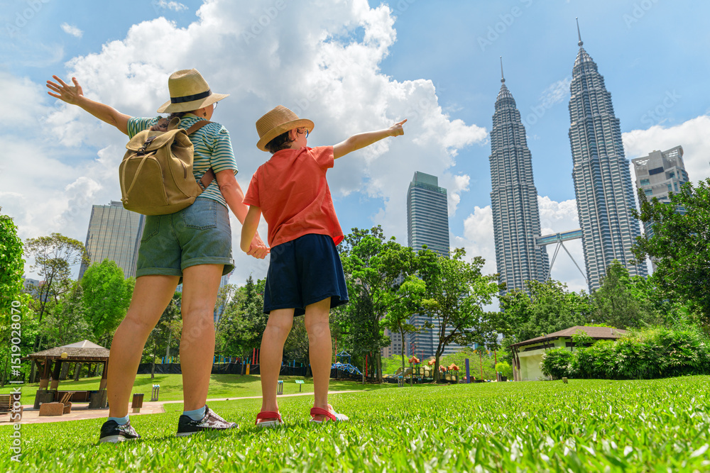 Obraz premium Female tourist and her son enjoying cityscape of Kuala Lumpur