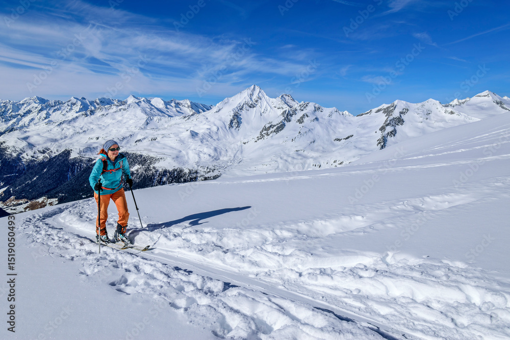 Woman back country skiing at Settelspitze in Rieserferner-Ahrn Nature Park, Venediger Group, High Tauern, Ahrntal, South Tyrol, Italy Woman back country skiing at Settelspitze in Rieserferner-Ahrn Nature Park, Venediger Group, High Tauern, Ahrntal, South Tyrol, Italy