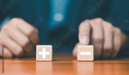 Konstfotografi Businessman using marked with plus and minus symbols