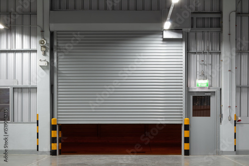 Shutter door or roller shutter inside industrial building at front. To construction for entrance of commercial, industrial building i.e. warehouse, factory, garage, hangar or shop suit for background.