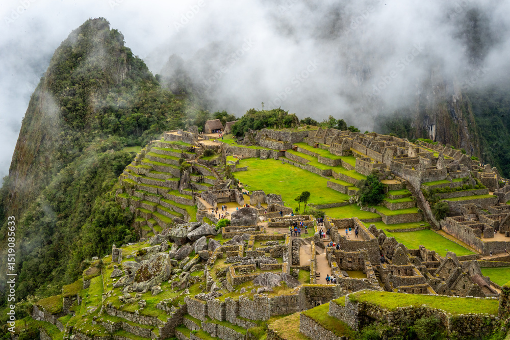 Fototapeta premium Panoramic view of Machu Picchu ruins surrounded by misty mountains, Peru