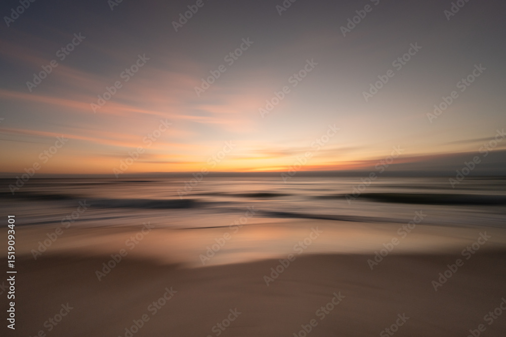 Fototapeta premium Silky smooth colorful ocean waves gently crash a tropical beach