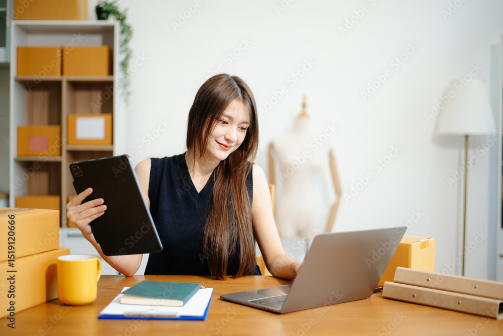 Young woman running online store Startup small business SME, using smartphone or tablet taking receive Young woman running online store Startup small business SME, using smartphone or tablet taking receive