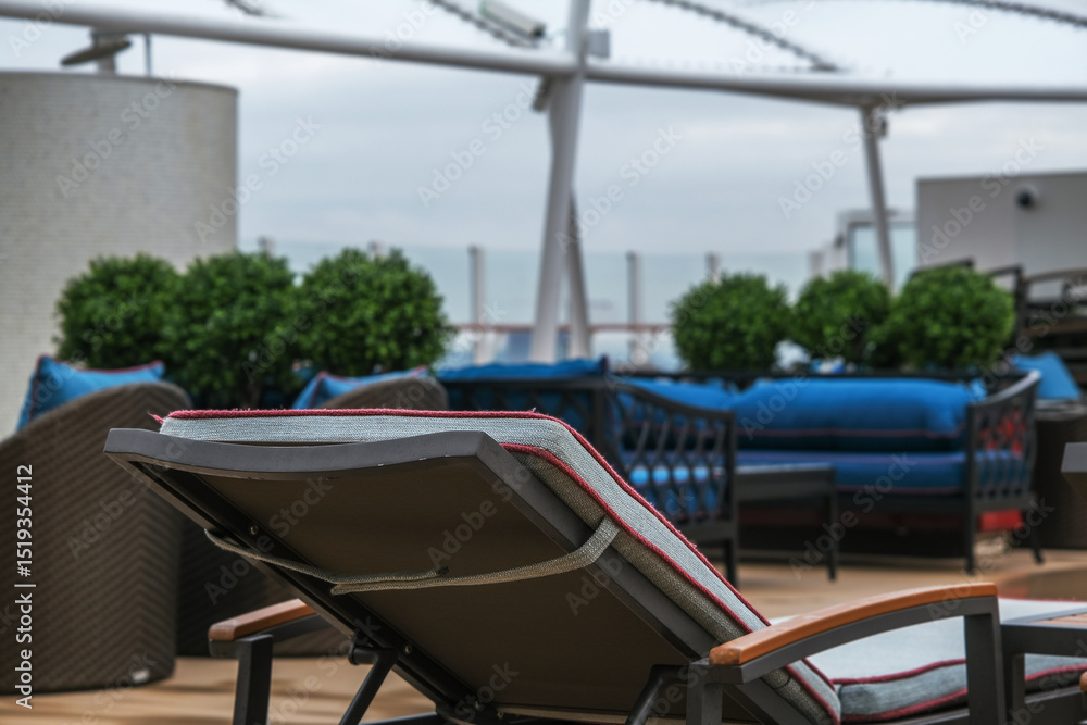 Fototapeta premium Outdoor whirlpool jacuzzi and private sun deck onboard modern luxury cruiseship cruise ship ocean liner with turquoise water, elegant rattan loungers and deck chairs for suite guests passengers