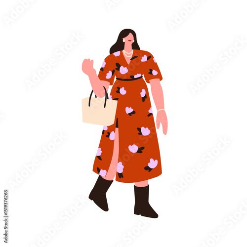 Woman walking in dress. Young attractive female holding bag, wearing boots an...