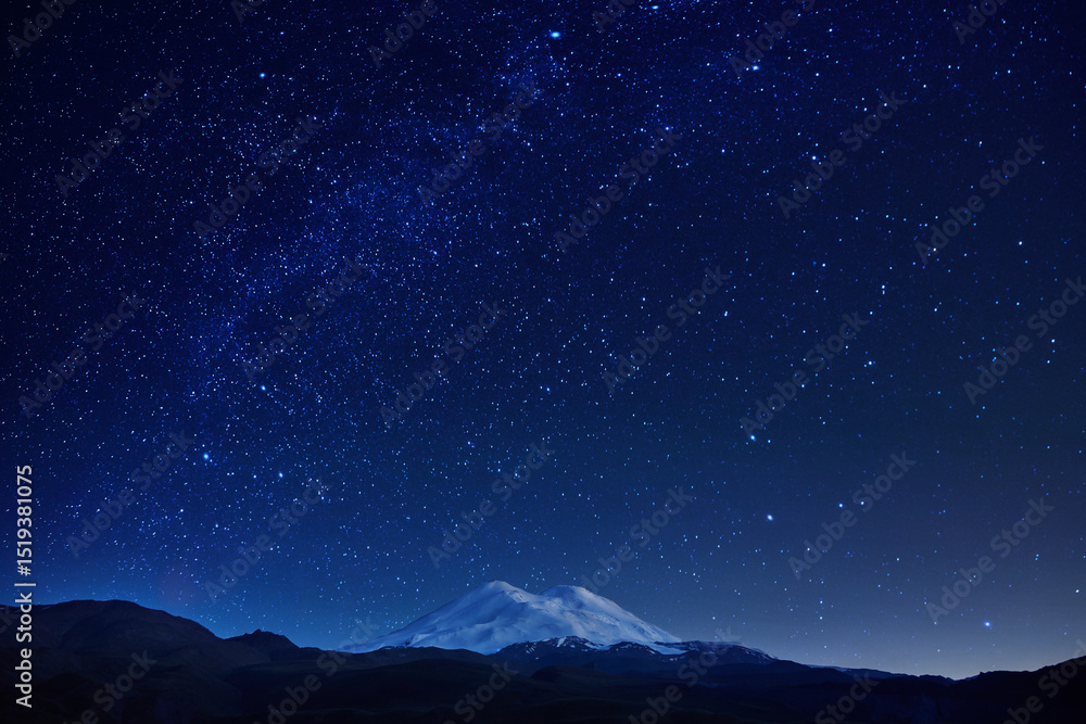 breathtaking view of a mountain with a snow-covered summit set against a clear night sky filled with vibrant stars and a rich backdrop of deep blue hues, creating a serene atmosphere breathtaking view of a mountain with a snow-covered summit set against a clear night sky filled with vibrant stars and a rich backdrop of deep blue hues, creating a serene atmosphere