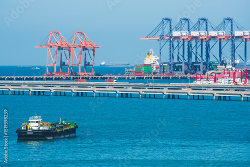 Logistic shipping quay boat Engineering crane depot at logistic export terminal control. Warehouse freight background container yard loading quayside harbor port. Logistics seascape shipping portal