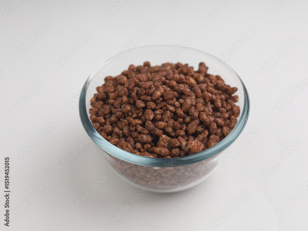 Chocolate cereal in a bowl served with milk Chocolate cereal in a bowl served with milk