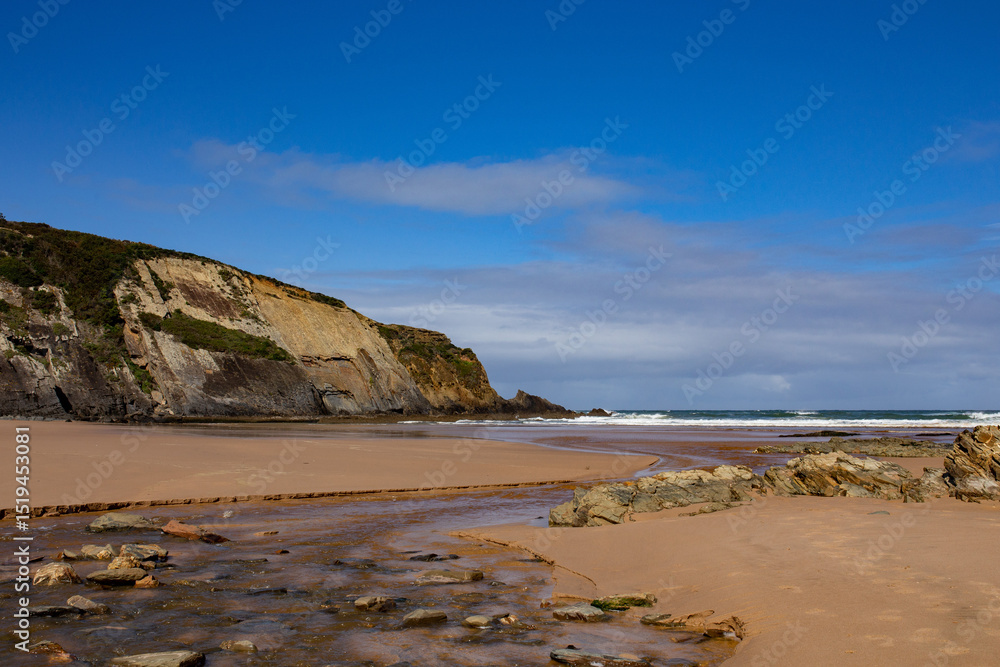 Layered Coastal Rocks and Blue Sky near Faro, Portugal Layered Coastal Rocks and Blue Sky near Faro, Portugal