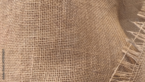 Jute pattern, rough burlap texture. Brown burlap cloth background or sack cloth for packing.