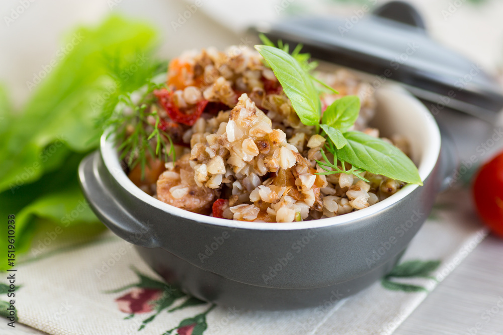 boiled buckwheat with vegetables in a ceramic bowl on a wooden table boiled buckwheat with vegetables in a ceramic bowl on a wooden table
