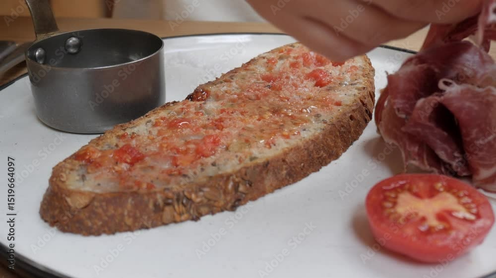 Tomato and ham toast on a plate with freshly sliced tomatoes and a small bowl Tomato and ham toast on a plate with freshly sliced tomatoes and a small bowl