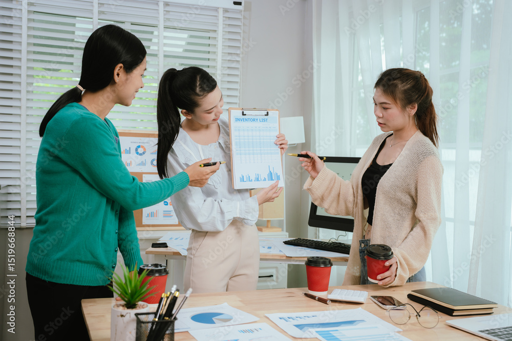 Fototapeta premium Diverse business team in modern office collaborating on startup strategy, analyzing charts, discussing growth, and planning successful marketing project.