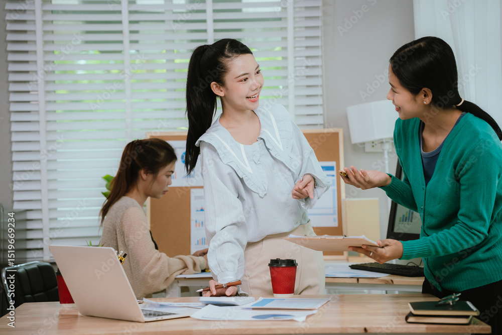 Fototapeta premium Diverse business team in modern office collaborating on startup strategy, analyzing charts, discussing growth, and planning successful marketing project.