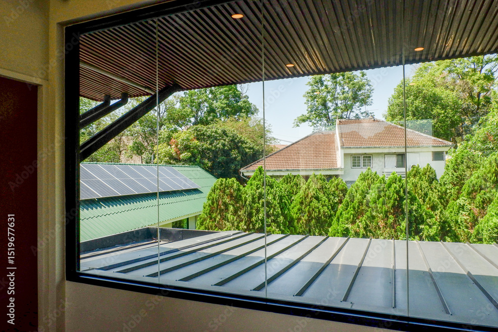 Fototapeta premium View from the window and the tree in summer,roof of house,cozy indoor home living room.