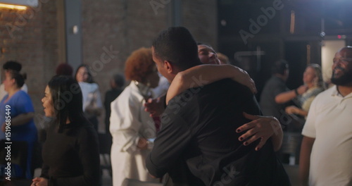 Obraz na plátně Diverse congregation members exchanging hugs and smiles in a modern church setti