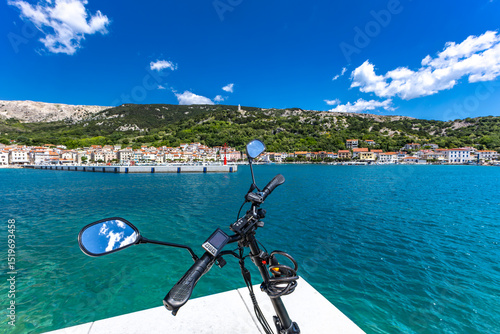 Fototapeta Naklejka Na Ścianę i Meble -  Cycling tour on the island of Baska, electric bike parked on a concrete platform by the beach in Baska