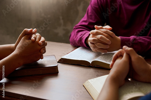 “Group Bible study with hands in prayer, reflecting spiritual connection, community, and meditation.”
